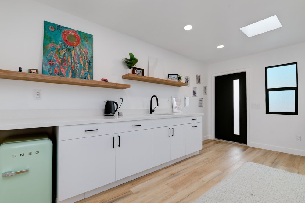 JADU kitchen with white oak shelving and quartz counters